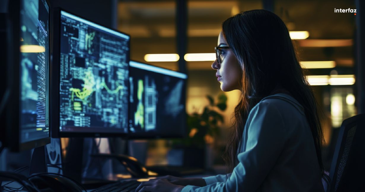 Woman in front of a computer working on the security of a software development plan